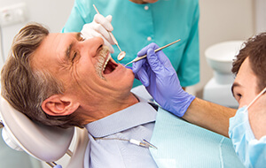 Senior man receiving dental exam