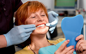 Woman looking at smile in mirror